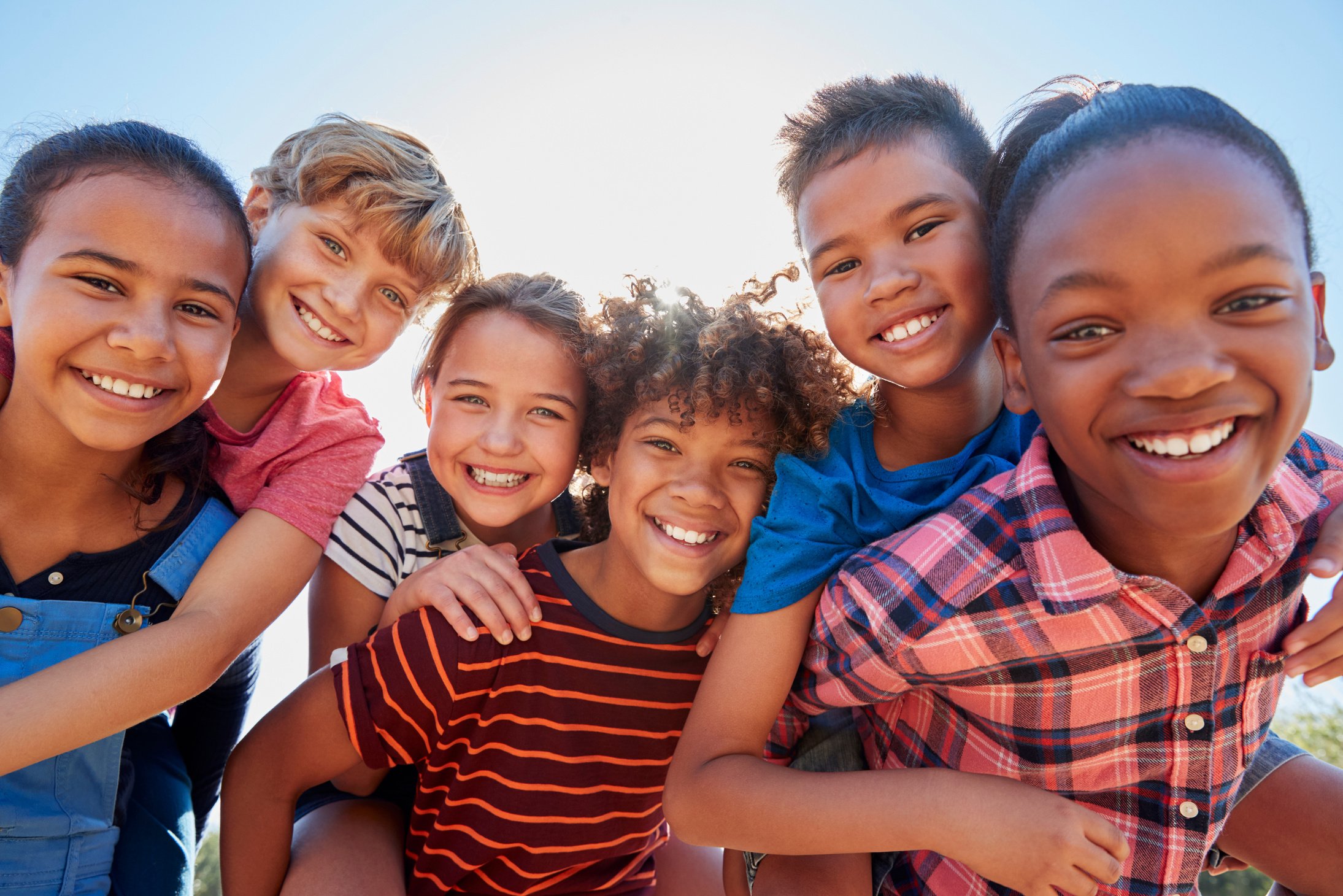 Six Pre-Teen Friends Piggybacking in a Park